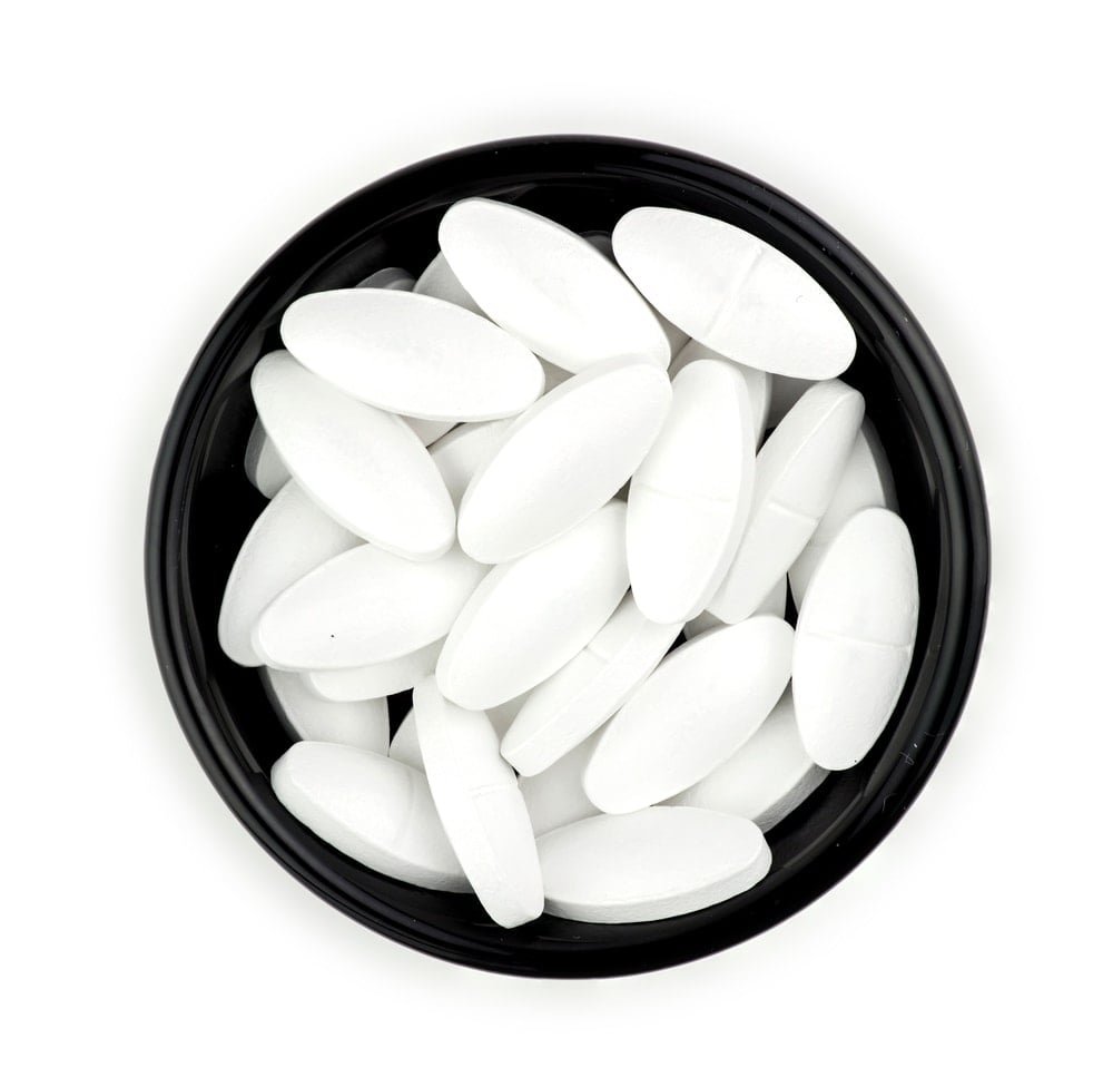 Calcium supplement tablet pills isolated on white